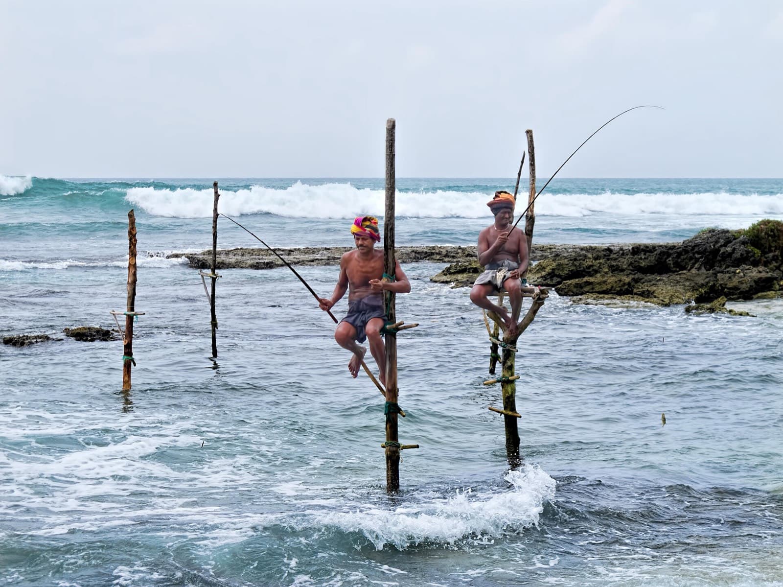 Stilt fishermen near Koggala. Agree a price before you photograph anyone.
